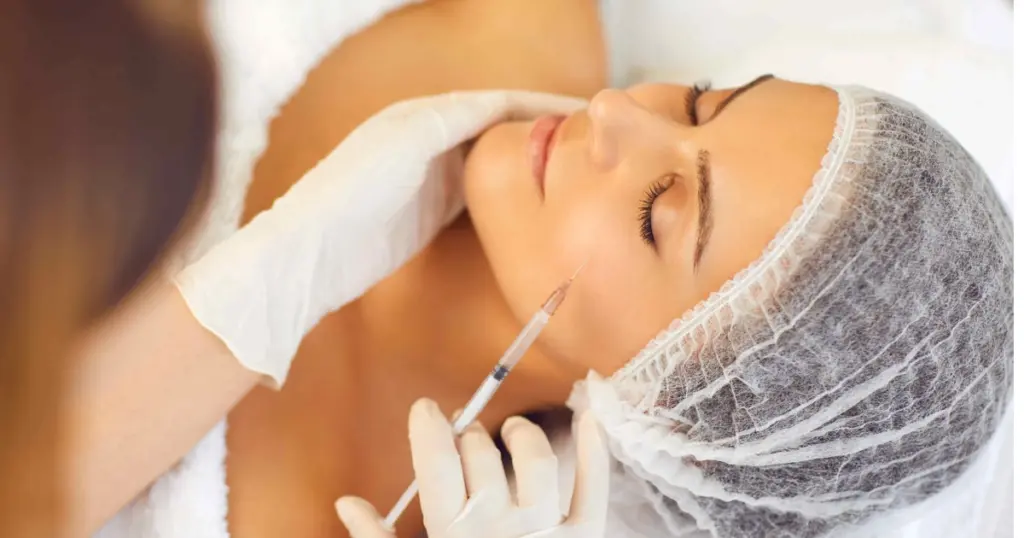 Aesthetic specialist administering Daxxify in Frederick, MD to a woman’s face for wrinkle reduction and smoother, youthful-looking skin.