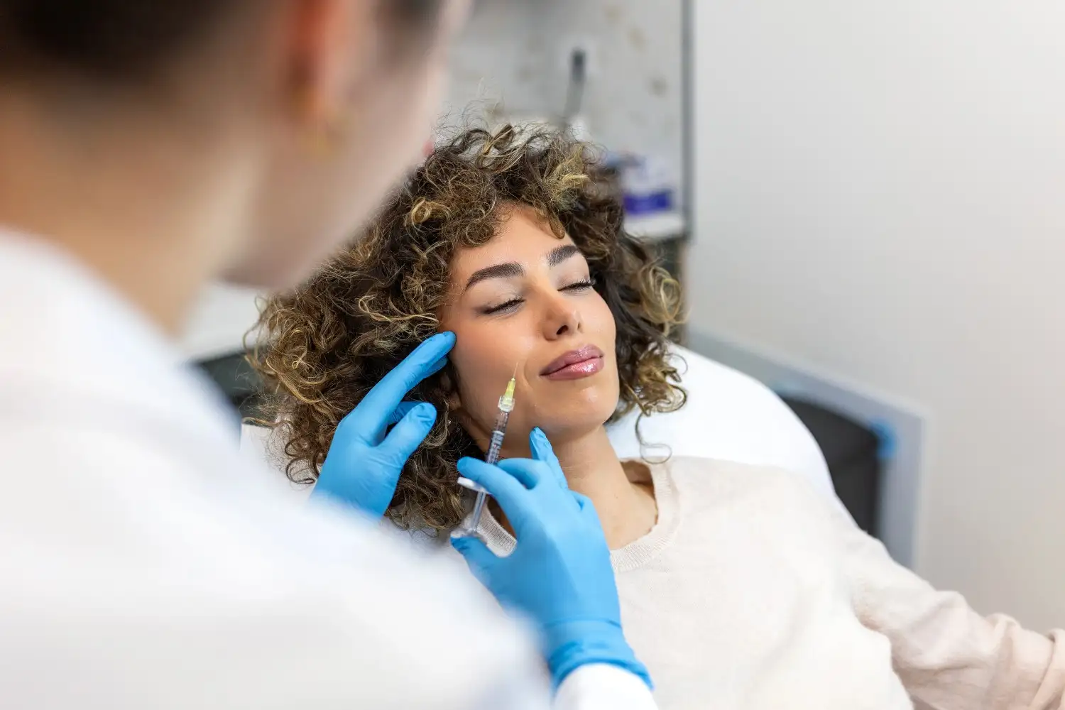 Patient receiving Botox injections during a cosmetic treatment to reduce facial wrinkles at a medical aesthetics clinic