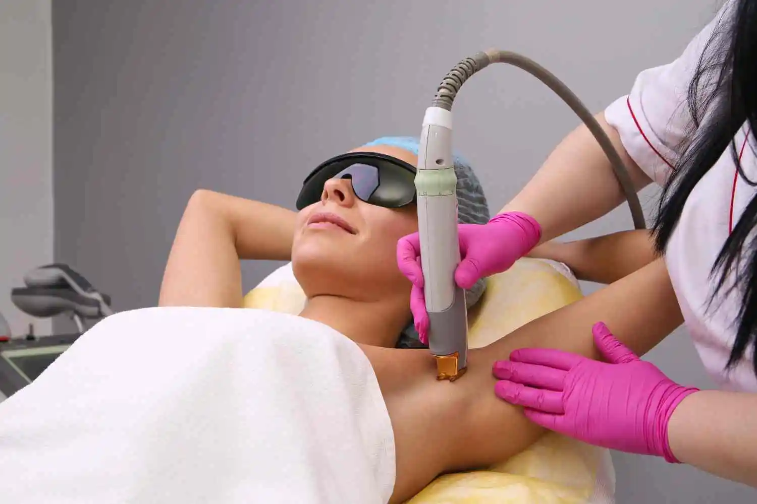 Woman receiving a laser hair removal treatment on her underarm